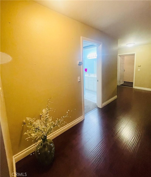 corridor with dark hardwood / wood-style flooring