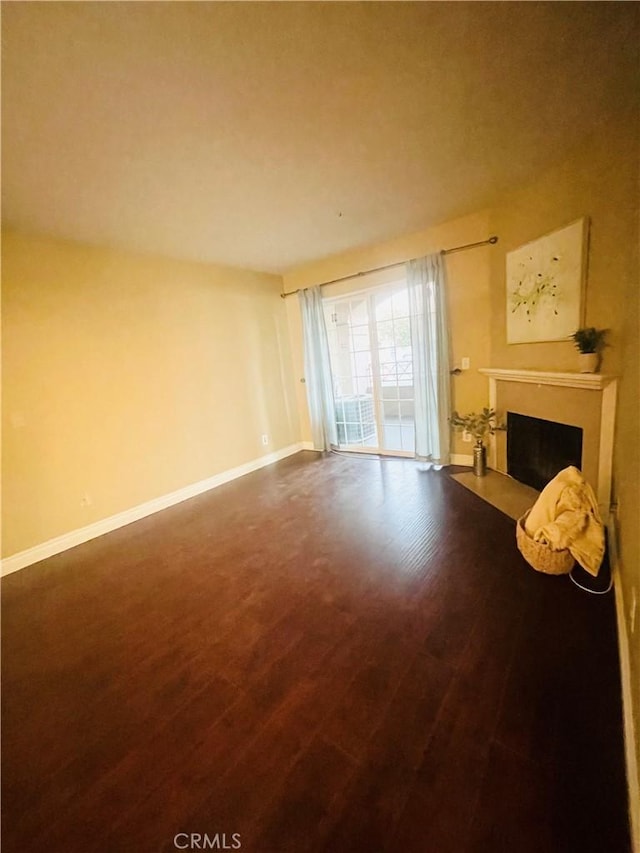 unfurnished living room featuring dark hardwood / wood-style floors