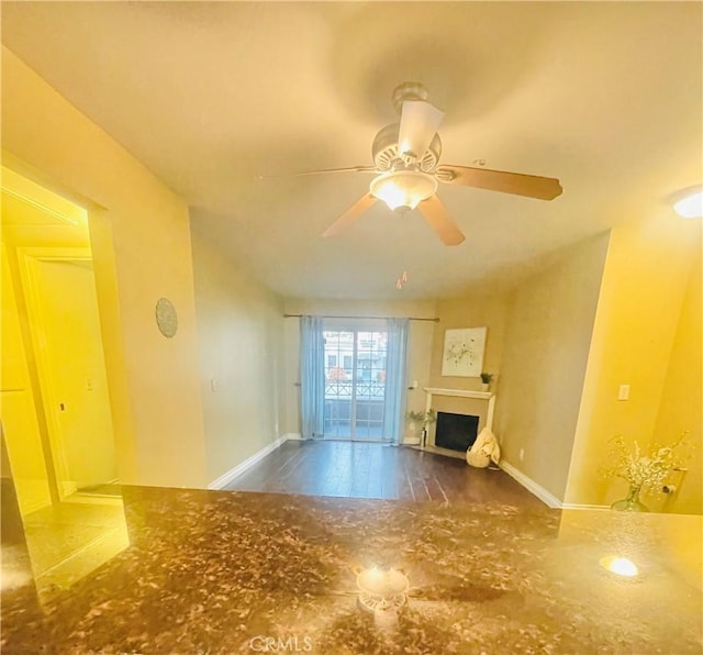 unfurnished living room featuring ceiling fan