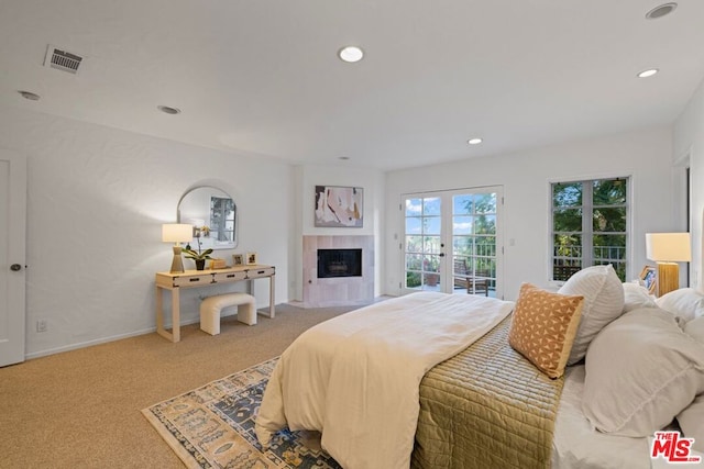 bedroom featuring carpet, access to outside, and a fireplace