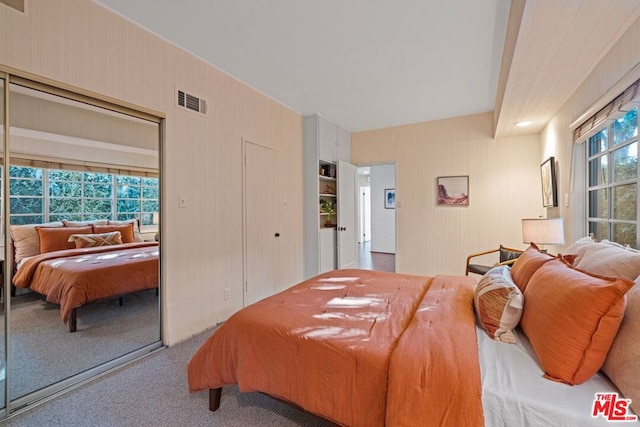 carpeted bedroom featuring multiple windows