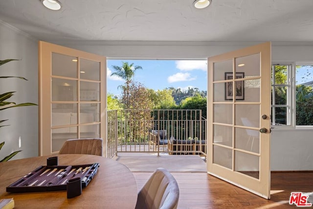 doorway to outside featuring french doors, crown molding, and hardwood / wood-style floors