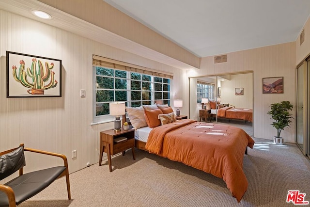 bedroom featuring light carpet and a closet