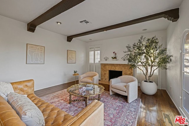 living room featuring dark wood-type flooring and beamed ceiling