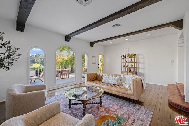 living room featuring hardwood / wood-style flooring, plenty of natural light, and beam ceiling