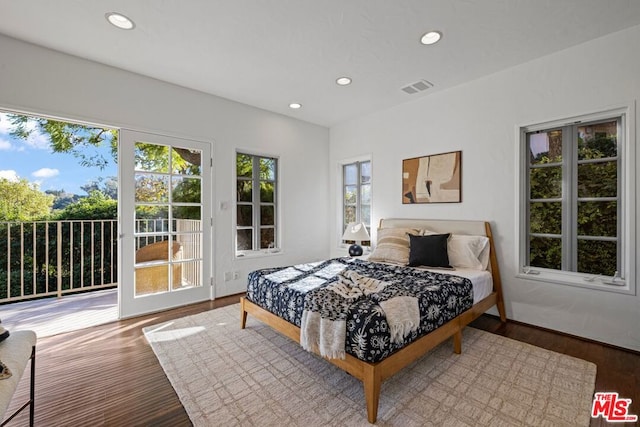 bedroom with access to exterior and wood-type flooring