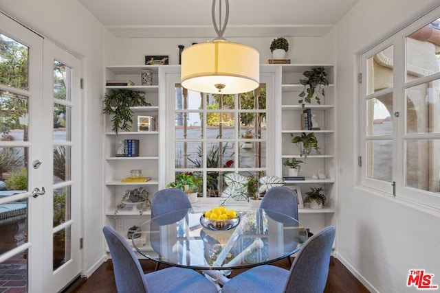 dining room with plenty of natural light, dark hardwood / wood-style flooring, and french doors