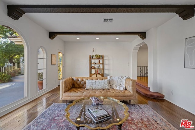 living room featuring beam ceiling and hardwood / wood-style flooring