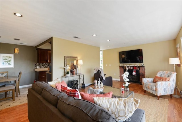 living room featuring light hardwood / wood-style floors and a fireplace