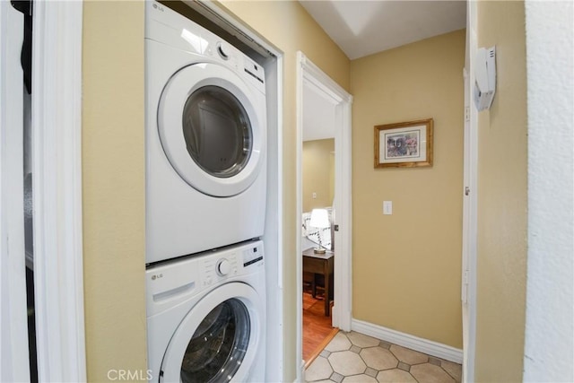 laundry room featuring stacked washer / drying machine