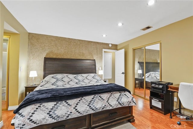 bedroom with light wood-type flooring and a closet