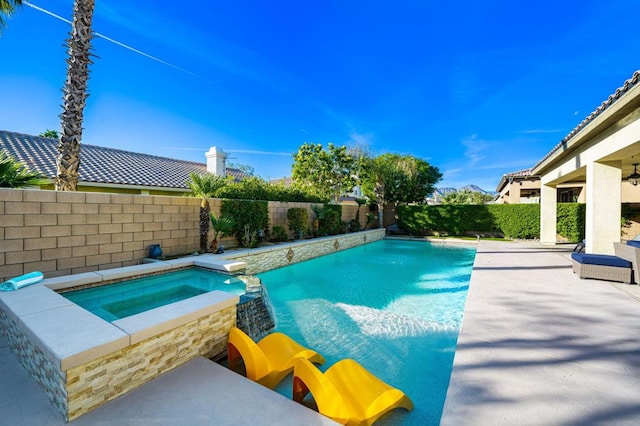 view of pool with an in ground hot tub