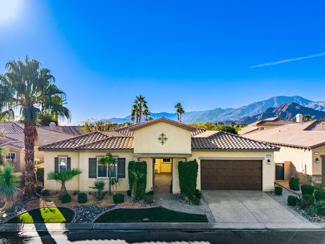 mediterranean / spanish-style home featuring a garage and a mountain view