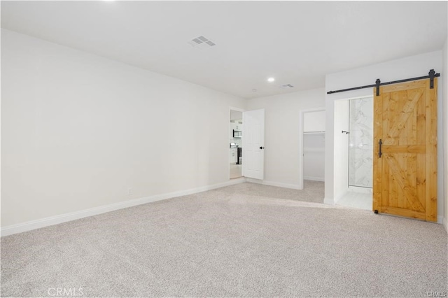 spare room featuring a barn door