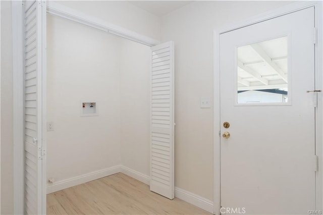 clothes washing area with light hardwood / wood-style flooring and hookup for a washing machine