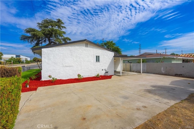 view of property exterior with a patio area