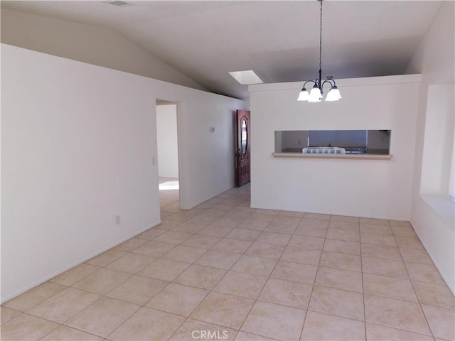 interior space with a notable chandelier, vaulted ceiling, and light tile patterned floors