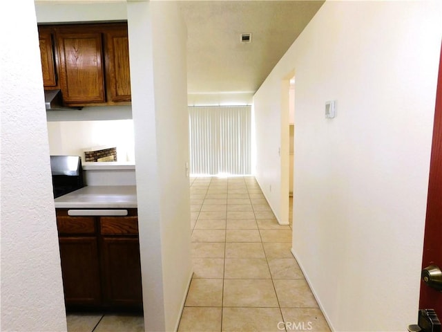 hallway featuring light tile patterned flooring