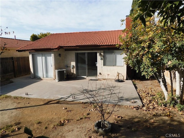 rear view of property with a patio and central air condition unit