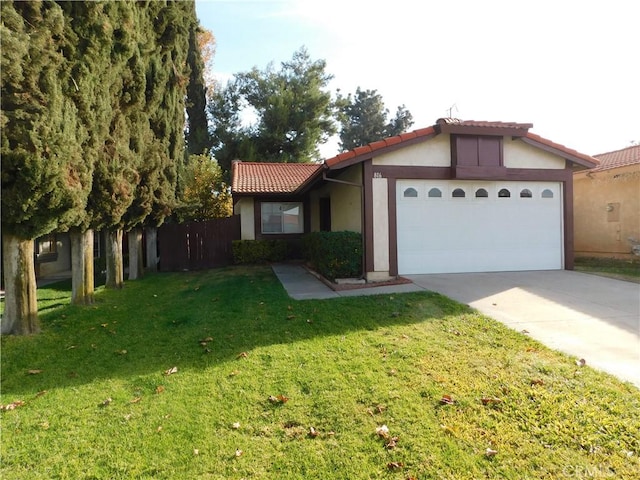 view of front of property with a garage and a front lawn