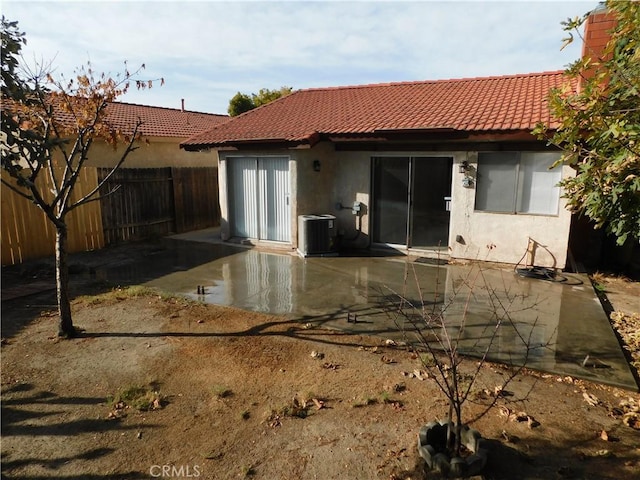 rear view of property featuring a patio and cooling unit