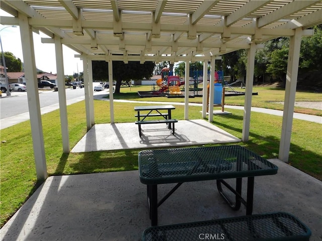 view of home's community with a yard, a pergola, a patio area, and a playground