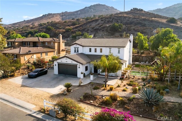 view of front of home with a garage and a mountain view