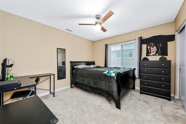 bedroom featuring ceiling fan, a closet, and light colored carpet