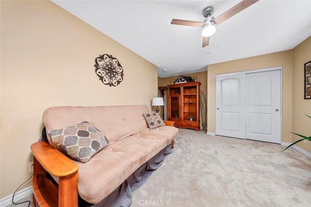 living room featuring light carpet and ceiling fan