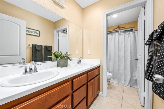 bathroom featuring toilet, tile patterned floors, and vanity