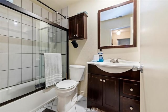 full bathroom featuring bath / shower combo with glass door, toilet, tile patterned flooring, and vanity