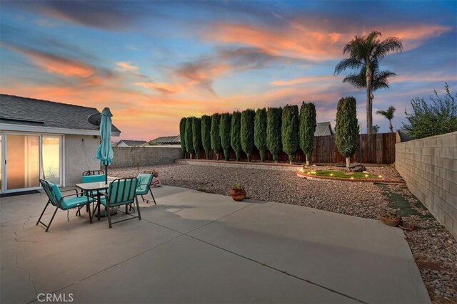 view of patio terrace at dusk