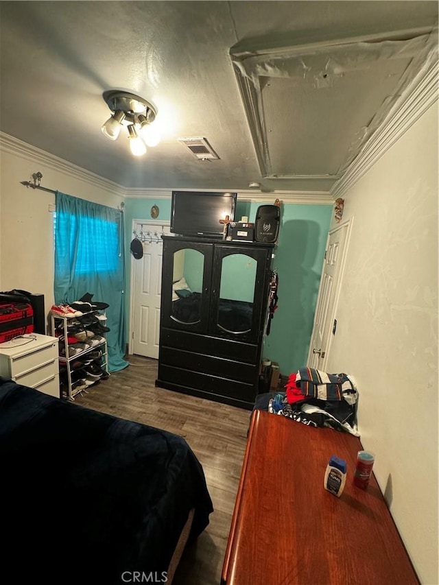 bedroom featuring hardwood / wood-style floors and ornamental molding