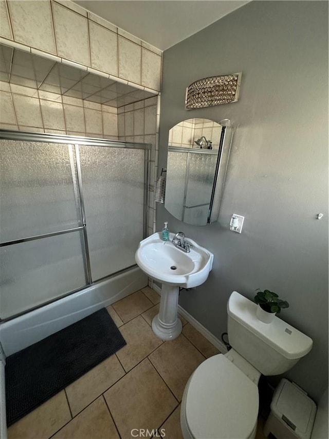 bathroom with walk in shower, tile patterned floors, and toilet