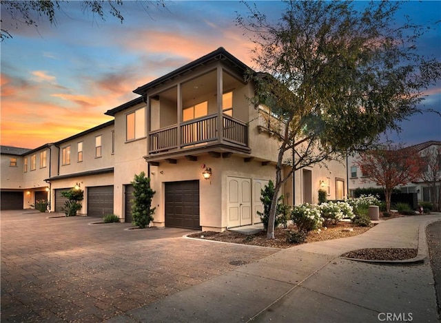 view of front of home with a garage and a balcony