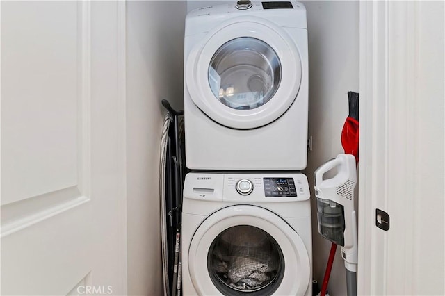 laundry area with stacked washing maching and dryer