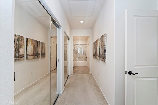 hallway featuring light carpet