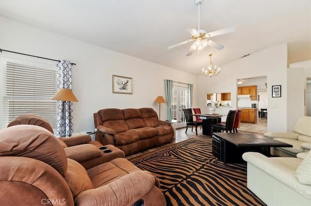 living room with lofted ceiling and ceiling fan with notable chandelier