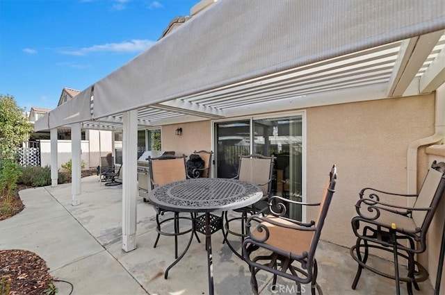 view of patio with a pergola, outdoor dining area, and fence