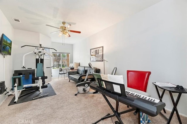 workout room featuring visible vents, ceiling fan, carpet floors, and baseboards