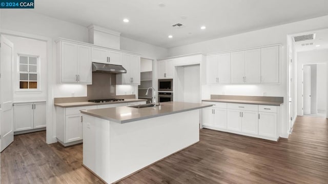 kitchen featuring sink, white cabinets, a center island with sink, and gas cooktop