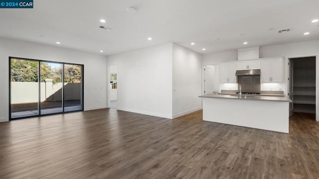 kitchen featuring white cabinetry, dark hardwood / wood-style floors, and an island with sink