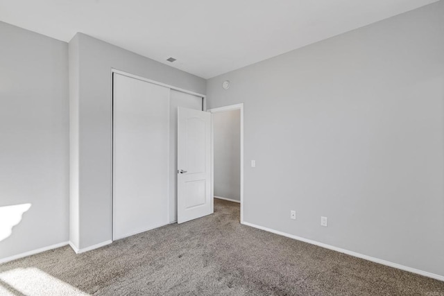 unfurnished bedroom featuring a closet and carpet