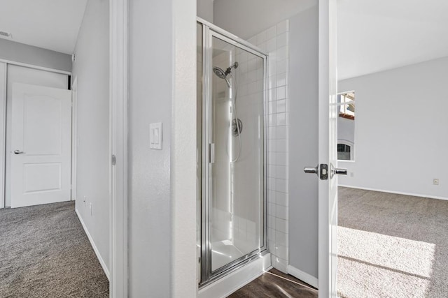 bathroom featuring a shower with door