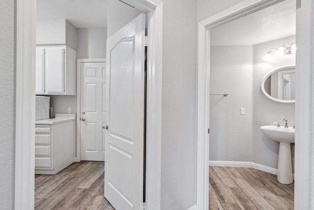 bathroom with hardwood / wood-style flooring and sink