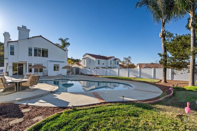 view of swimming pool featuring a patio and a hot tub