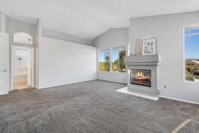 unfurnished living room featuring vaulted ceiling, a multi sided fireplace, and carpet