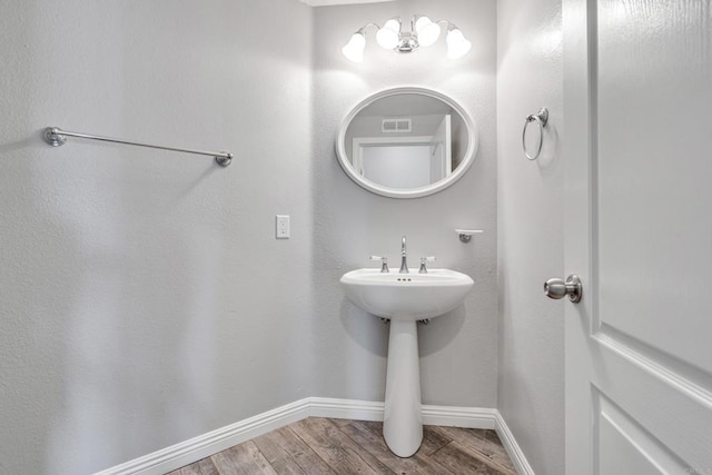 bathroom with hardwood / wood-style floors