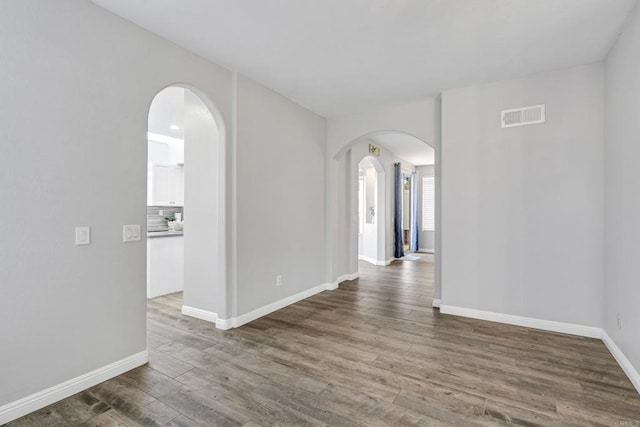 empty room with dark hardwood / wood-style flooring