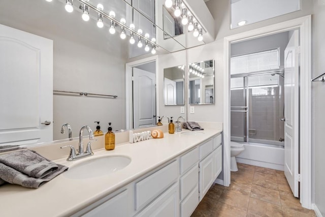 full bathroom featuring toilet, vanity, and enclosed tub / shower combo